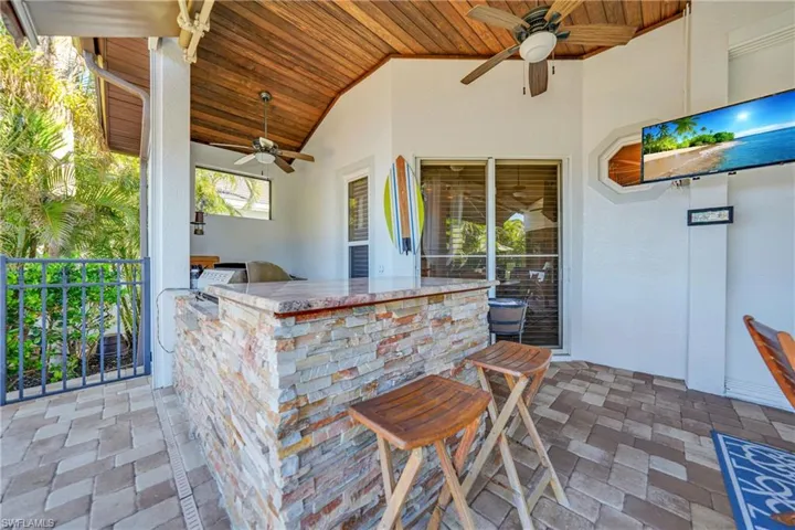 View of patio featuring ceiling fan and an outdoor bar