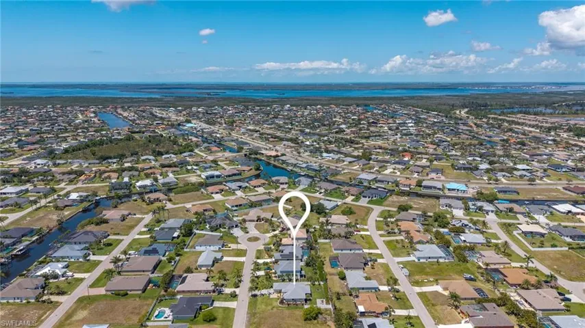 Birds eye view of property with a residential view and a water view