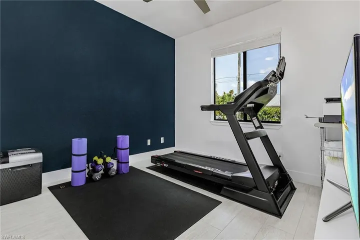 Workout room featuring baseboards and ceiling fan