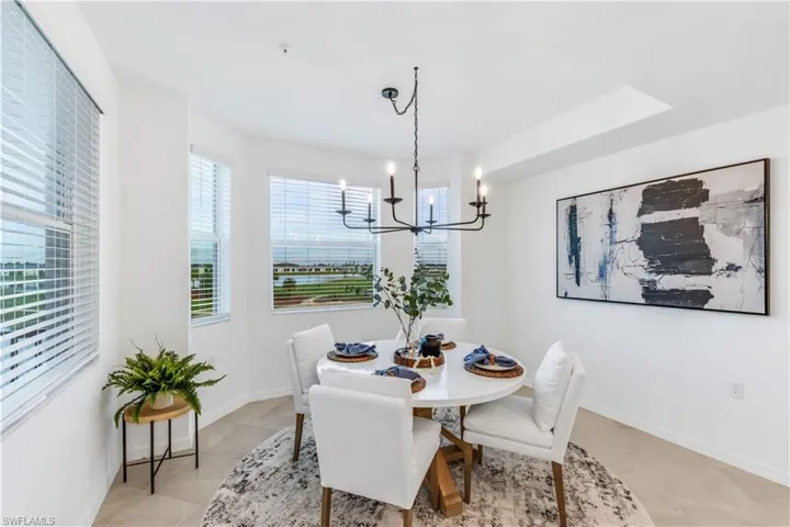 Tiled dining space featuring a notable chandelier