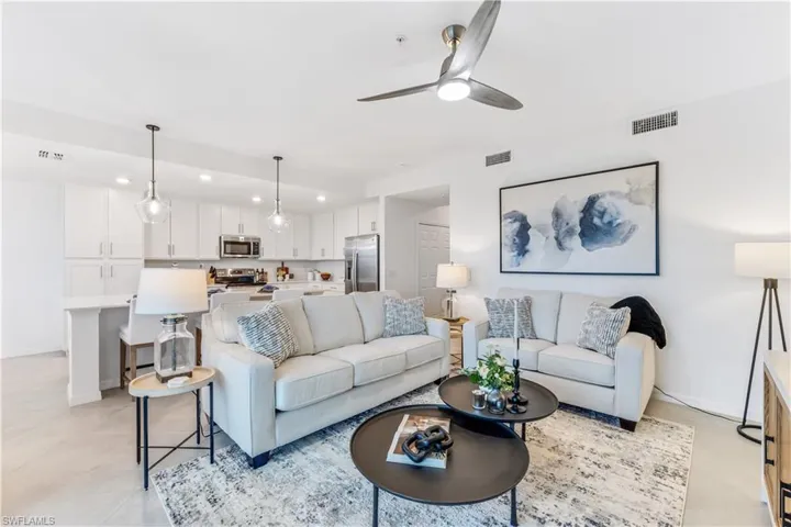 Living room with ceiling fan and light tile patterned floors