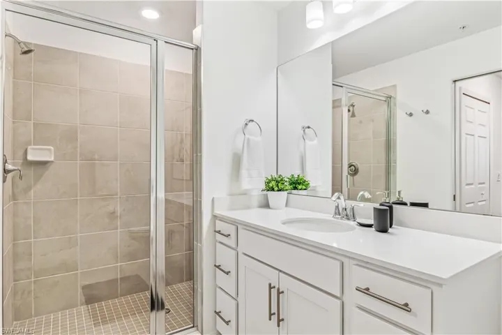Bathroom featuring walk in shower and vanity