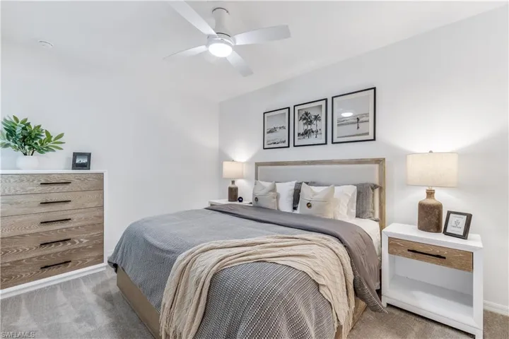 Carpeted bedroom with ceiling fan