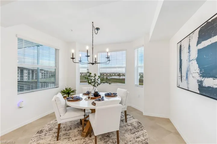 Tiled dining area with a chandelier