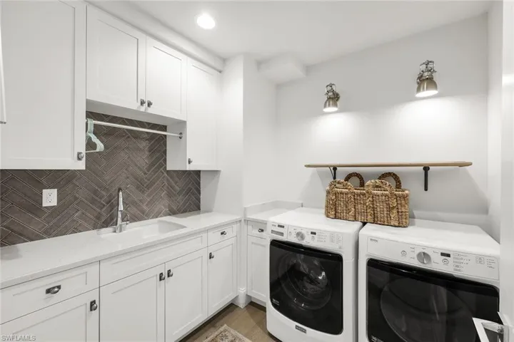 Laundry room with plenty of storage and a laundry sink.