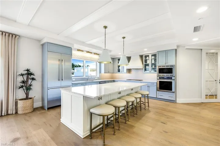 Gorgeous upgrades in the kitchen include custom pendant lighting, custom painted cabinetry, a large island, glass cabinet doors and so much more.