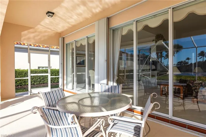 Covered lanai for outdoor dining and lounging.