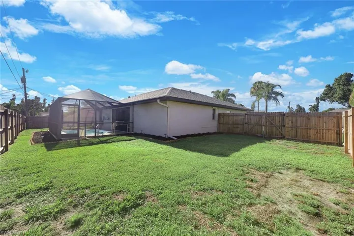View of yard with a swimming pool and a lanai