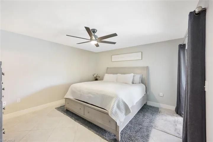 Tiled bedroom with ceiling fan