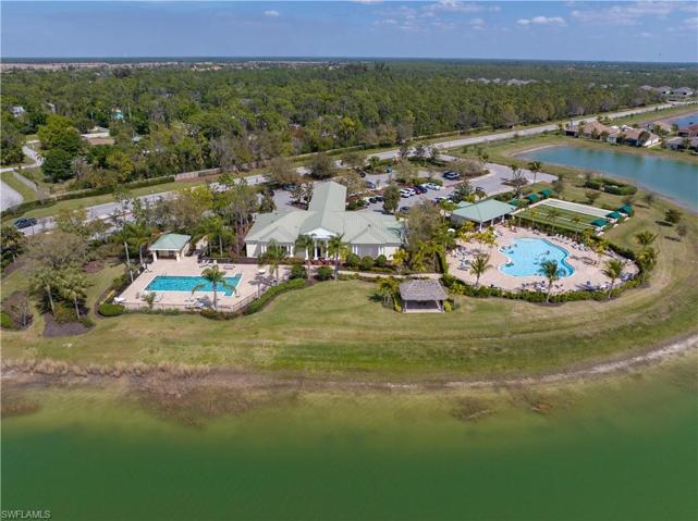 Clubhouse with 2 pools, tiki hut, bocce ball, shuffleboard and lake view.