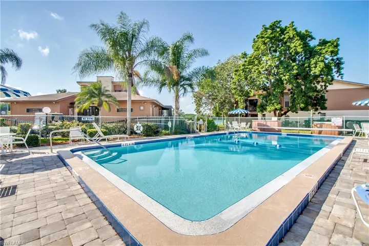 One of three Community pools featuring fence and a patio
