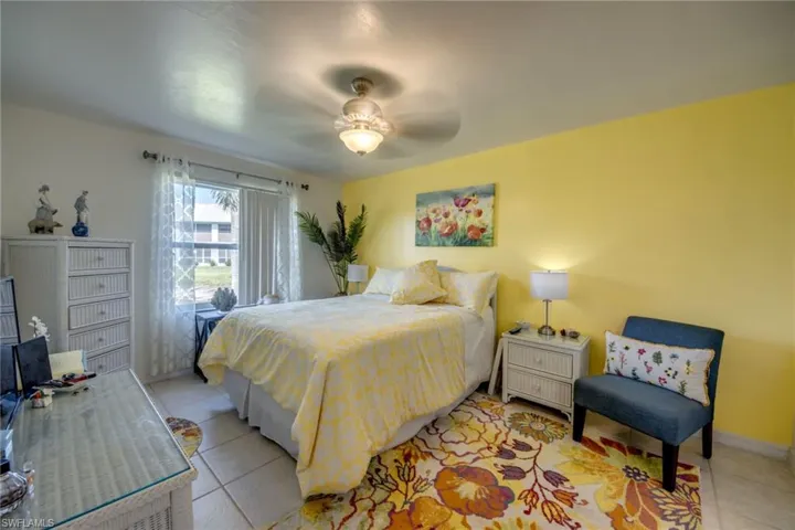 Gorgeous primary bedroom, light and airy with a lake view
