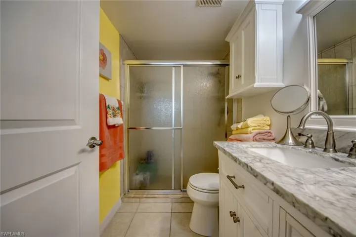 Primary ensuite bathroom features walk-in shower, new vanity, toilet, cabinet, lighting and mirror