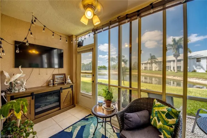 Screened in lanai with a water view and a ceiling fan