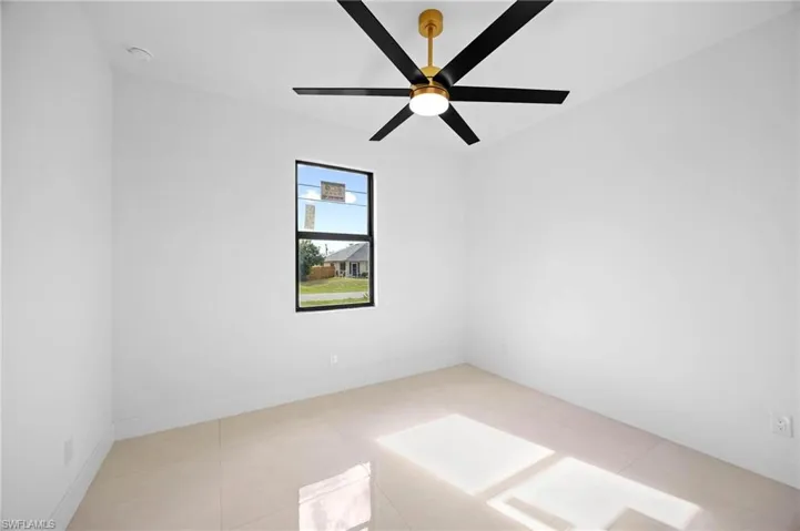 Unfurnished room with baseboards and light tile patterned flooring