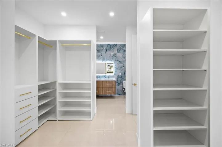 Spacious closet featuring light tile patterned floors