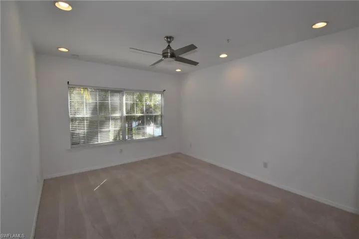 Unfurnished room with light carpet, recessed lighting, and a ceiling fan
