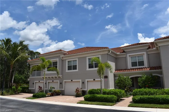 Mediterranean / spanish home with stucco siding, a tile roof, driveway, and an attached garage
