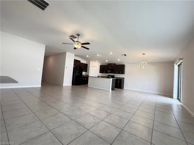 Unfurnished living room featuring light tile patterned floors, a ceiling fan, a textured ceiling, and recessed lighting