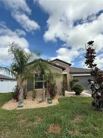 View of front of property with an attached garage and stucco siding