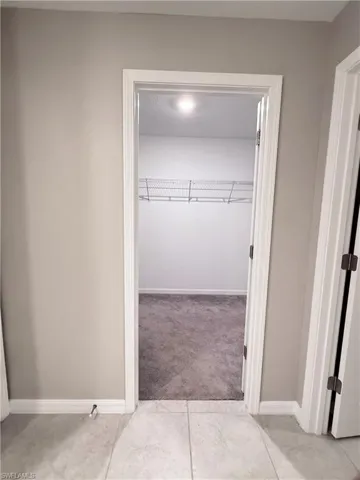 Bathroom featuring baseboards and light tile patterned flooring