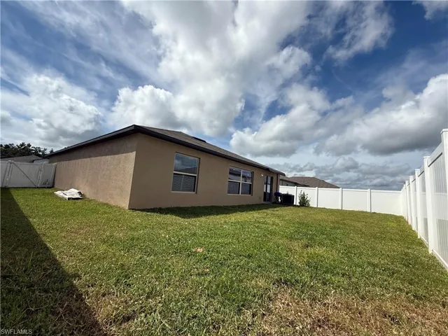 View of home's exterior featuring stucco siding and a fenced backyard