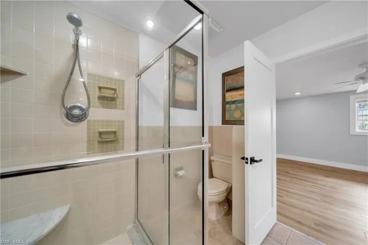 Bathroom with a stall shower, recessed lighting, tile patterned floors, and ceiling fan