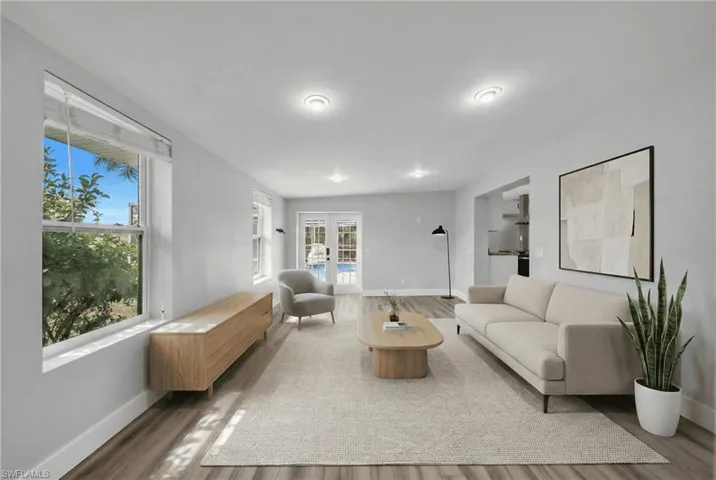 Living room with french doors and wood finished floors