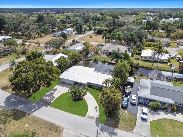 Aerial perspective of suburban area featuring a nearby body of water
