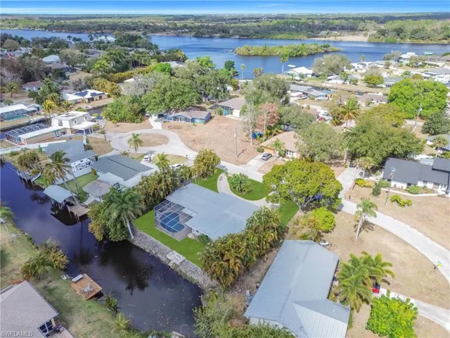 Aerial perspective of suburban area featuring a large body of water