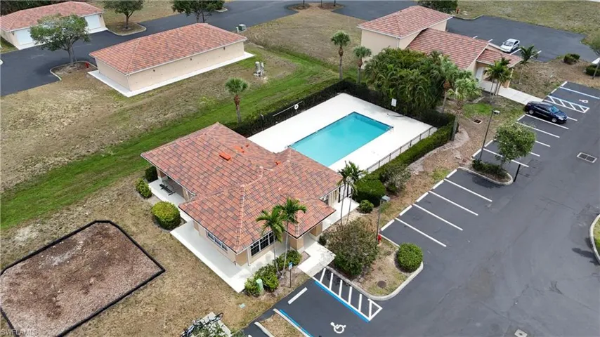 Community swimming pool and amenity building with tile roofing