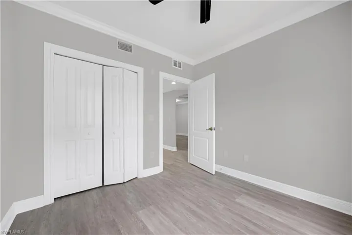 Light gray interior walls with white crown molding and baseboards