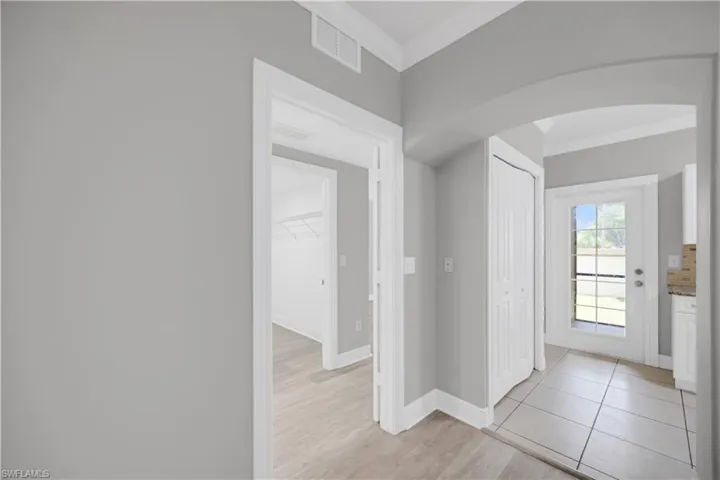 Interior hallway featuring light gray walls and white trim