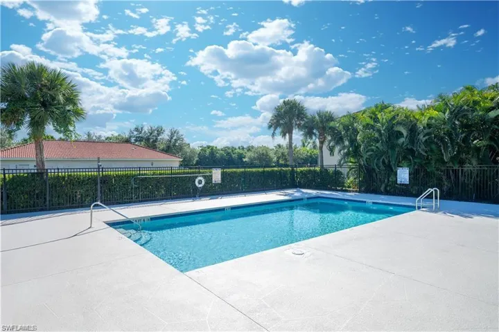 Rectangular swimming pool with integrated steps, surrounded by a light-toned concrete deck