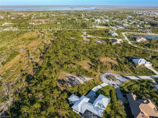 Aerial overview of property's location featuring a large body of water and nearby suburban area