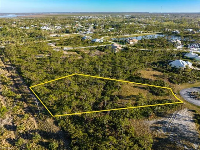 Aerial perspective of suburban area featuring property boundaries highlighted