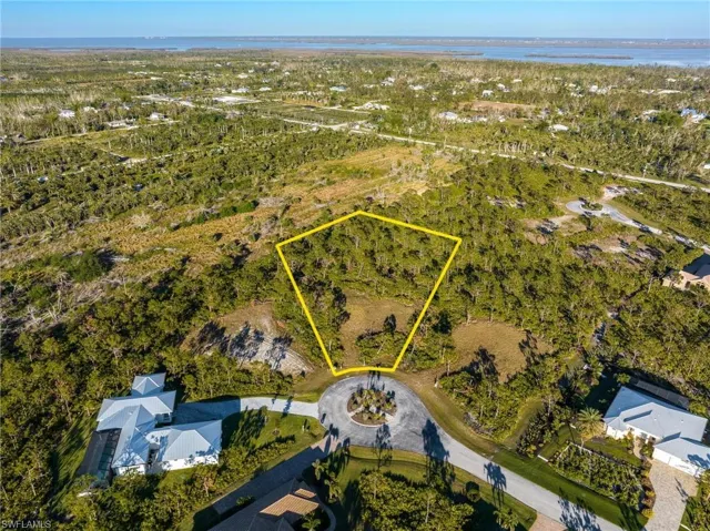 Aerial overview of property's location with property boundaries highlighted and a large body of water