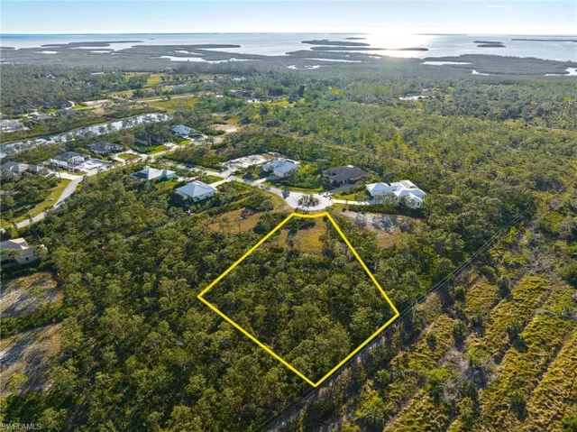 Aerial overview of property's location featuring a nearby body of water and property parcel outlined