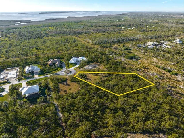 Aerial view of property's location featuring property parcel outlined and a large body of water