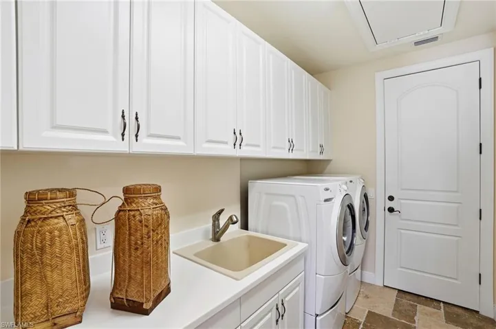 Wash, dryer, and a ton of storage with a laundry sink and access to the trash chute