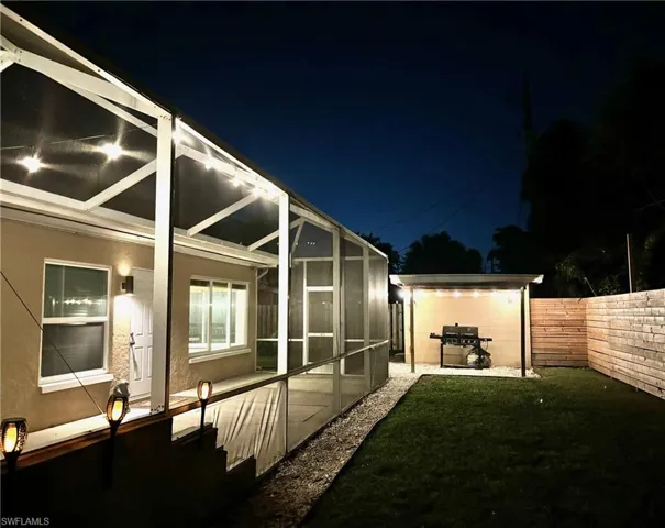 Yard at twilight featuring a patio area and a lanai