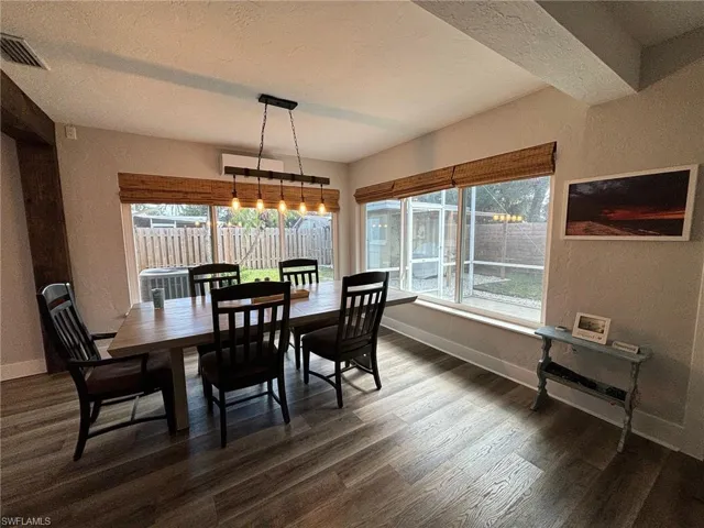 Dining room with dark hardwood / wood-style floors