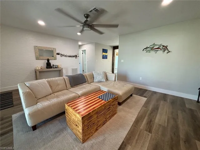Living room featuring hardwood / wood-style flooring and ceiling fan