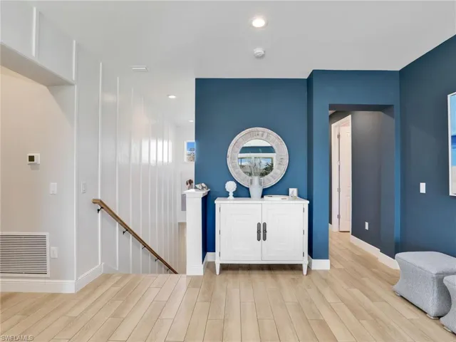 Foyer entrance with recessed lighting, visible vents, baseboards, and wood finished floors