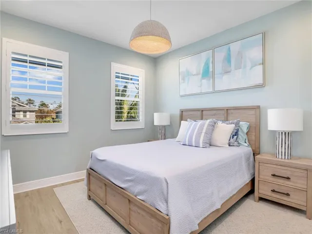 Bedroom featuring baseboards and wood finished floors