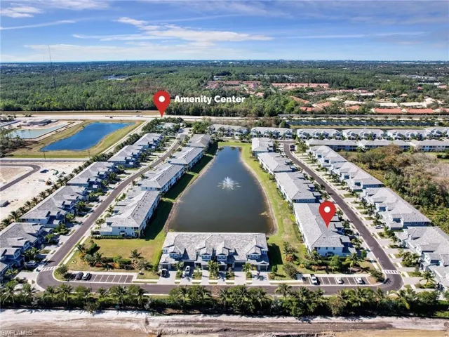 Birds eye view of property with a water view