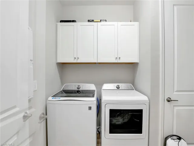 Clothes washing area with cabinet space and washer and dryer