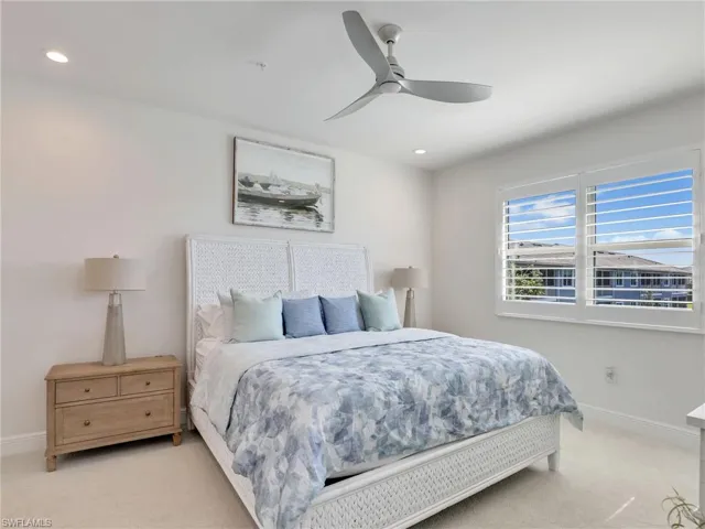 Bedroom with baseboards, ceiling fan, recessed lighting, and light colored carpet