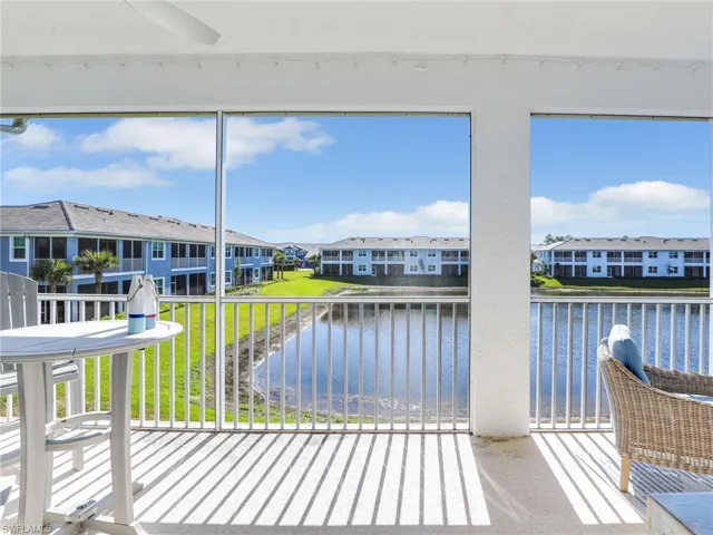 Sunroom with a water view and a residential view