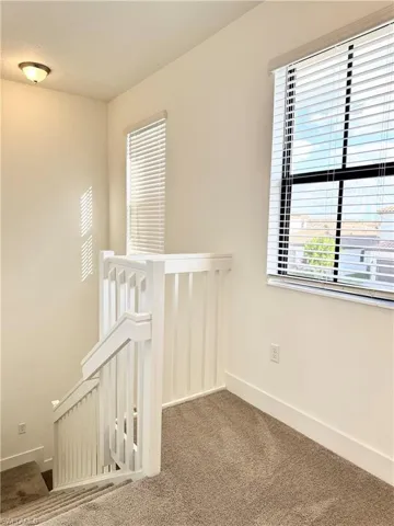 Hallway with carpet flooring